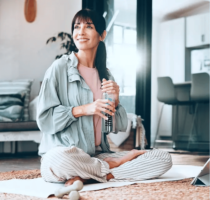 Hydrate4U woman doing yoga with a bottle of water